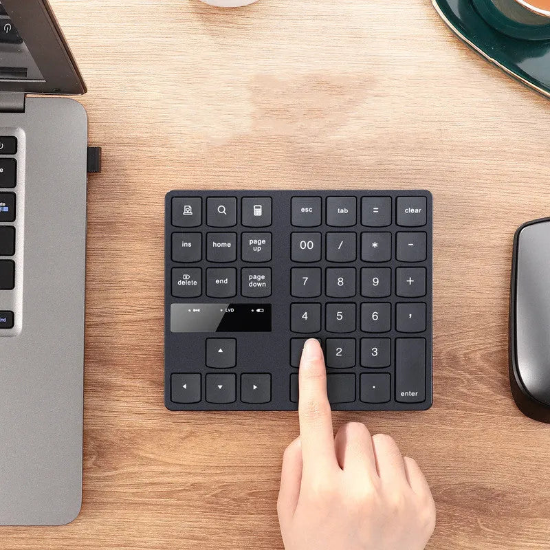 Black wireless numeric keyboard with 35 keys, ABS construction, 145x120x19mm dimensions, USB charging cable and receiver visible