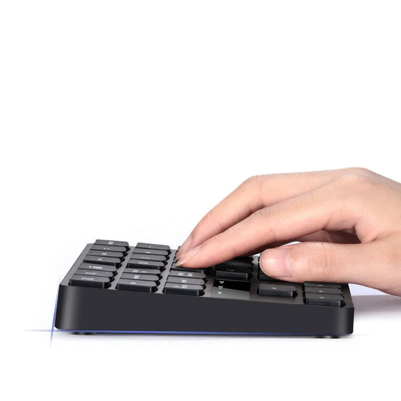 Black wireless numeric keyboard with 35 keys, ABS construction, 145x120x19mm dimensions, USB charging cable and receiver visible