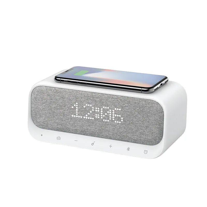 White Anker Soundcore Bluetooth speaker with wireless charging top and digital clock display.