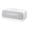 White Anker Soundcore Bluetooth speaker with wireless charging top and digital clock display.