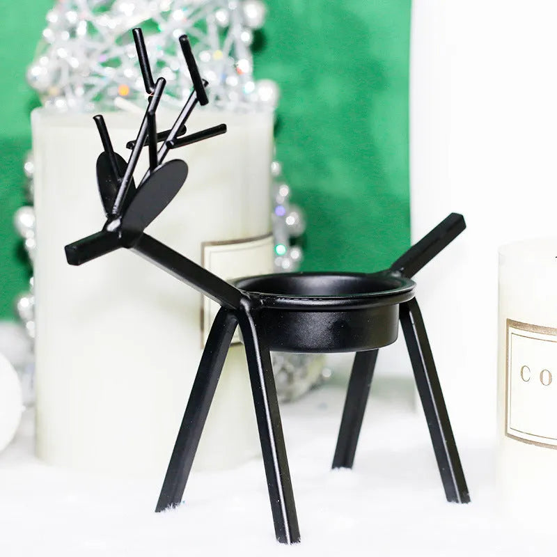 Black iron Christmas candlestick holder with decorative elk bracket design.