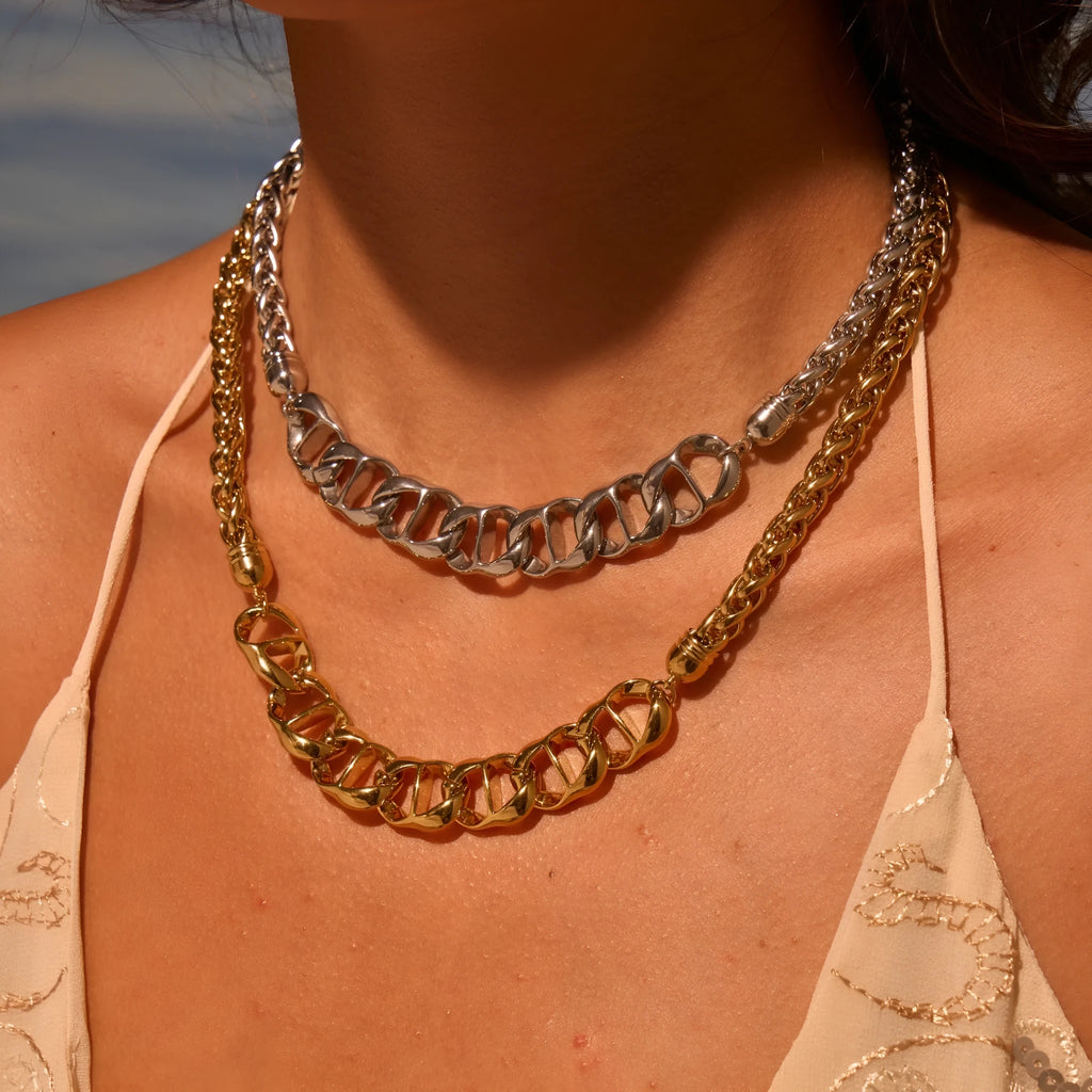 Stainless steel geometric pendant necklace with gold electroplated finish on a regular chain.