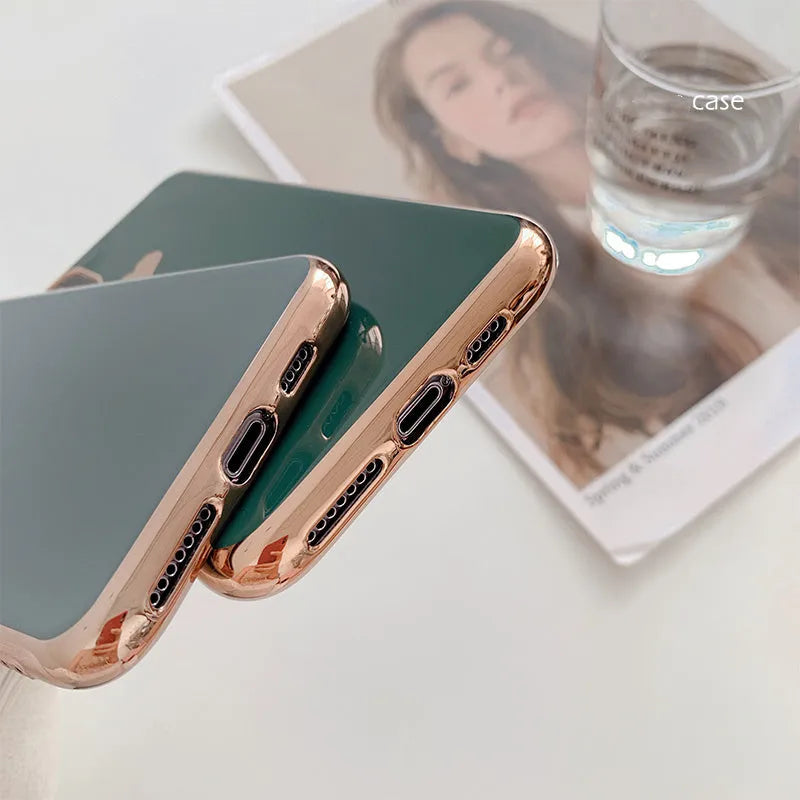 Solid colour TPU back cover case for iPhone on a table, showing blue, claret, pink, and green options.