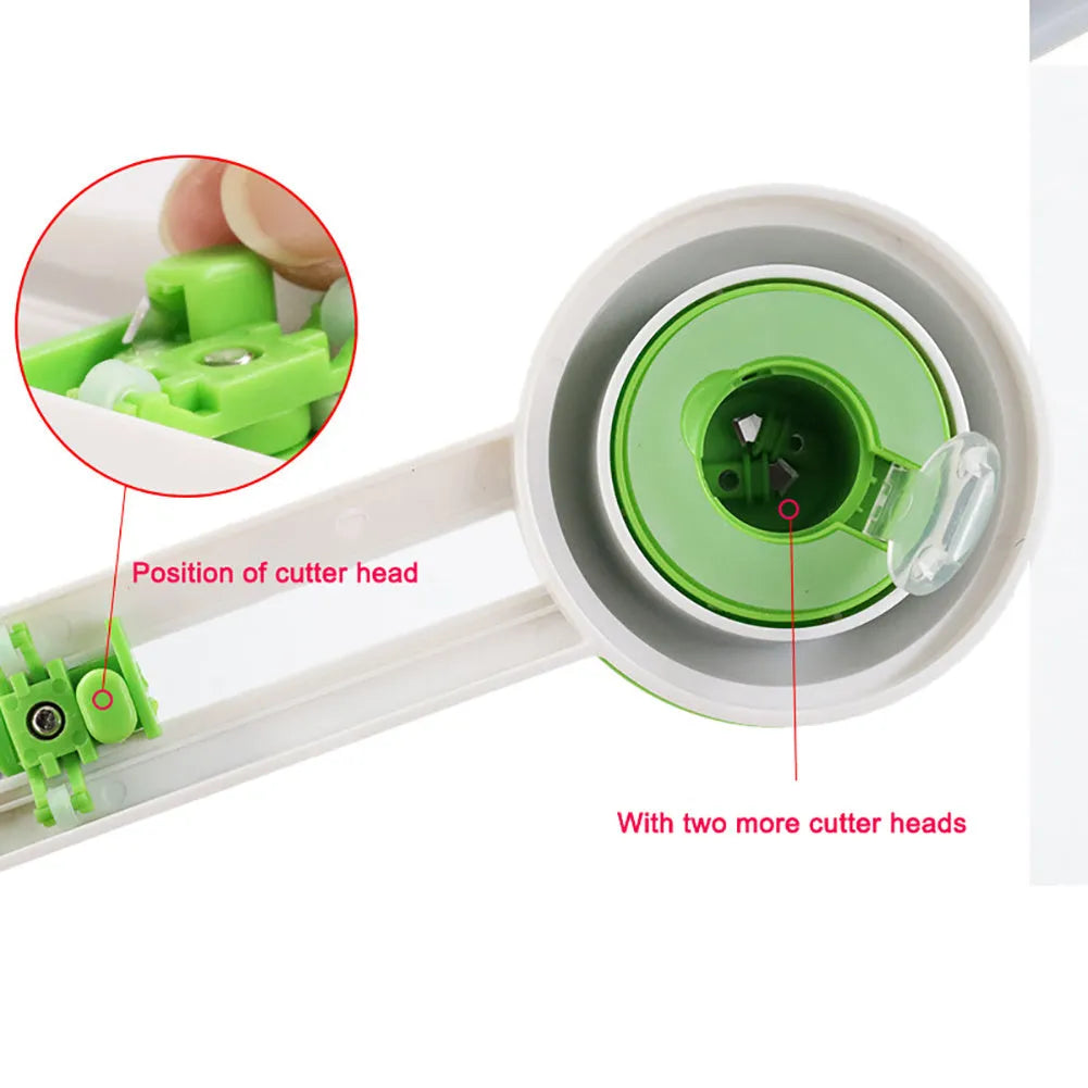 Green and orange plastic round paper cutter for cutting A3 sheets on a desk.