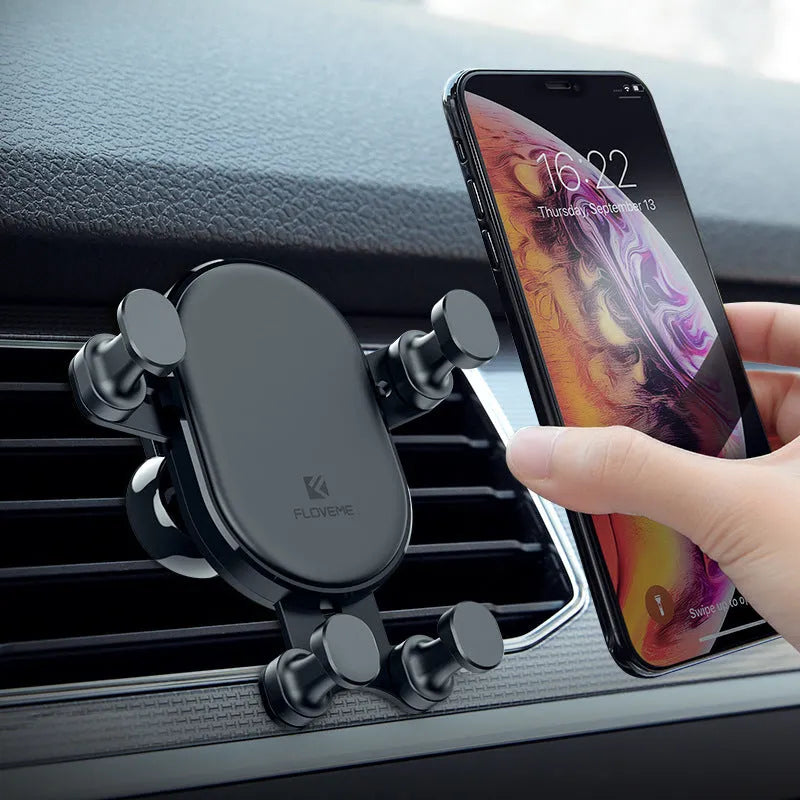 Black gravity car phone holder with 360-degree rotating head mounted on a car air vent.