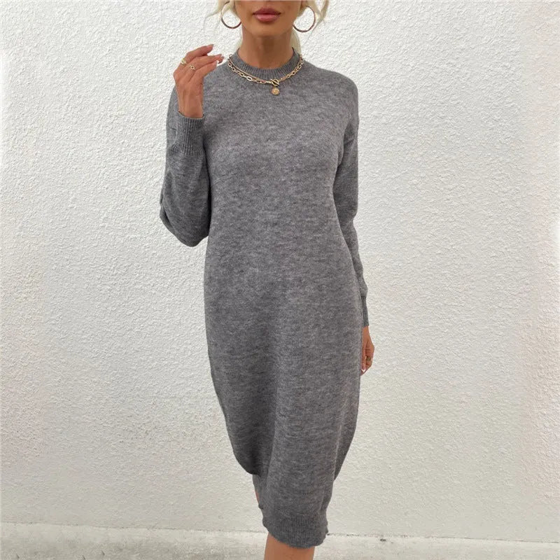 Grey women's crew neck acrylic pullover sweater on a hanger, showing long sleeves.