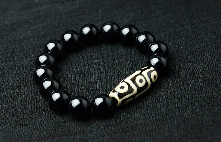 Natural black agate bracelet with nine eyes beads on neutral background, three size options 10mm 12mm 14mm