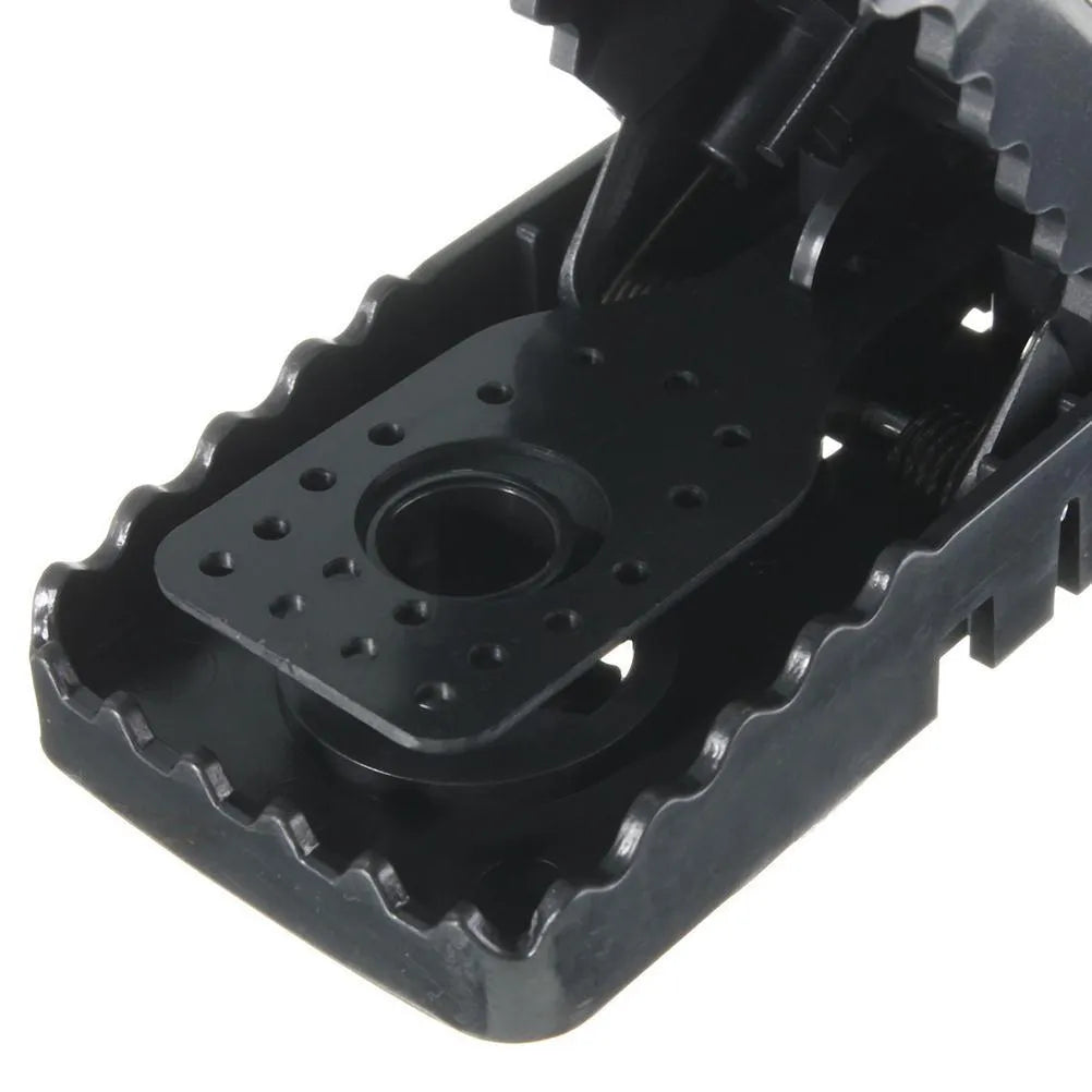 Six black plastic snapping mousetraps with metal trigger, shown on a white background.