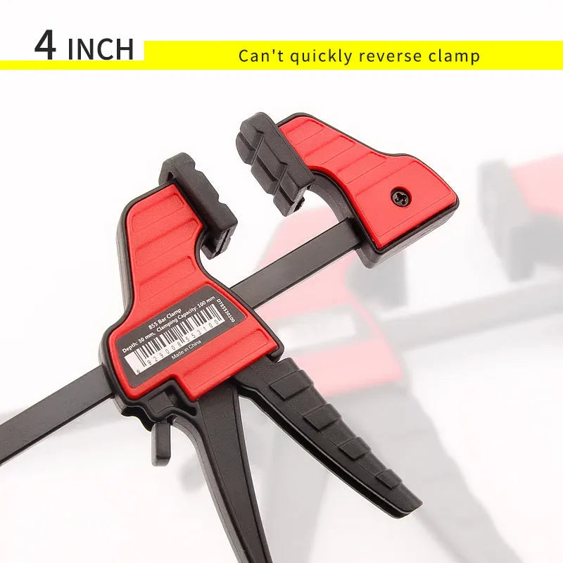 Black plastic woodworking clamp with quick release key and soft rubber grip pads