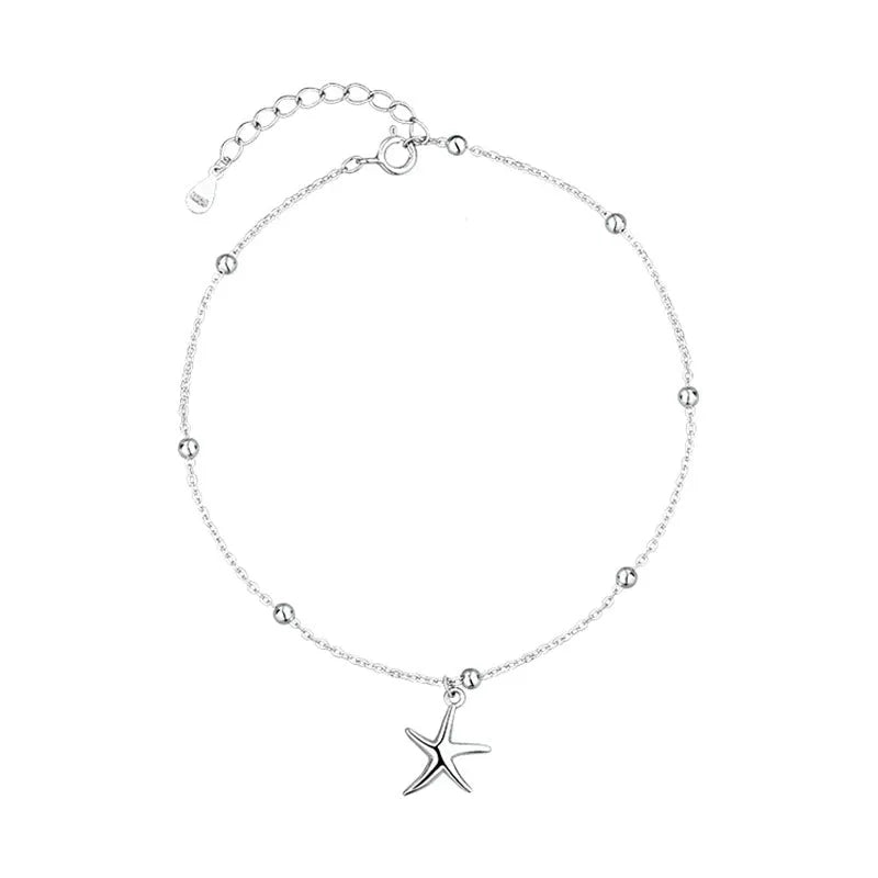 Adjustable sterling silver anklet with round beads and a small starfish charm on an ankle.