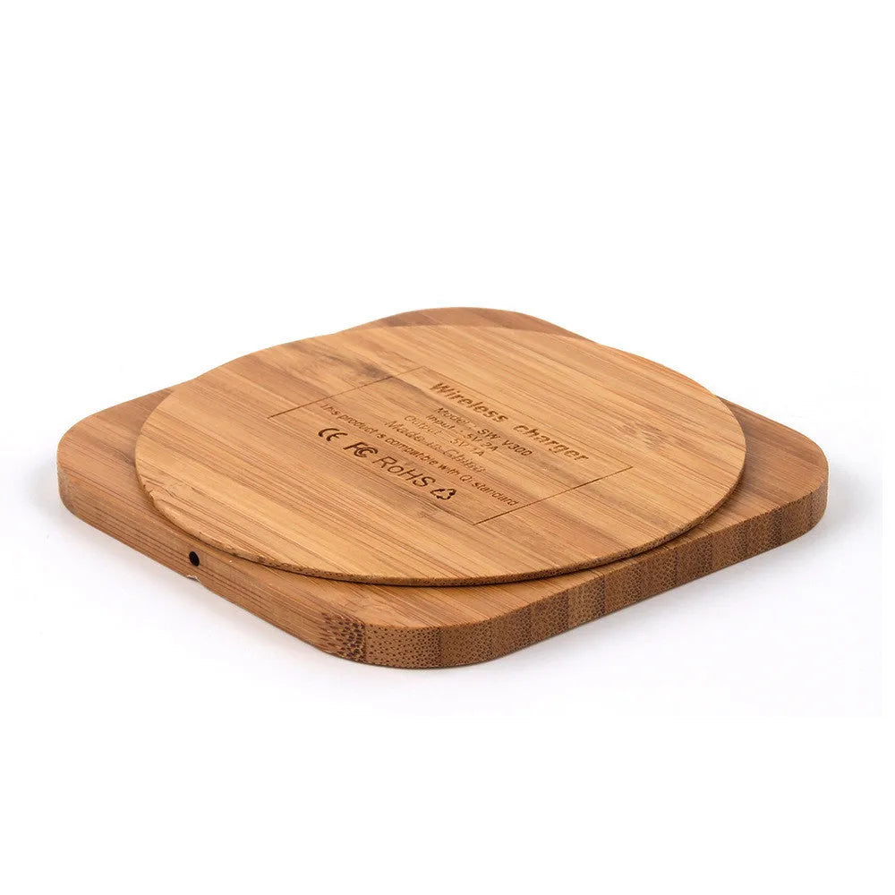 Square wooden bamboo 5W wireless charging pad on a table.