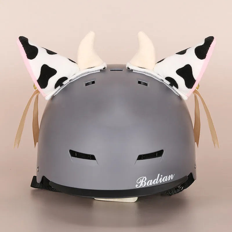 Colourful plush cartoon hat decoration sitting on top of a ski helmet
