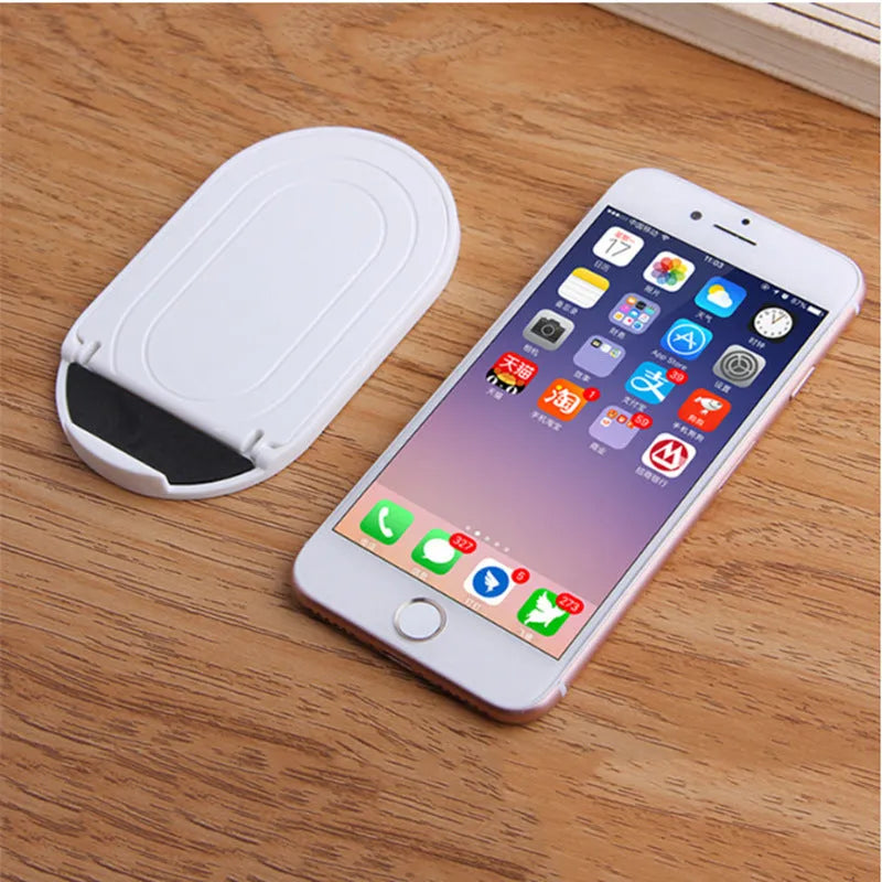 A plastic mobile phone stand with a lazy bracket mechanism shown in one of six colour options.