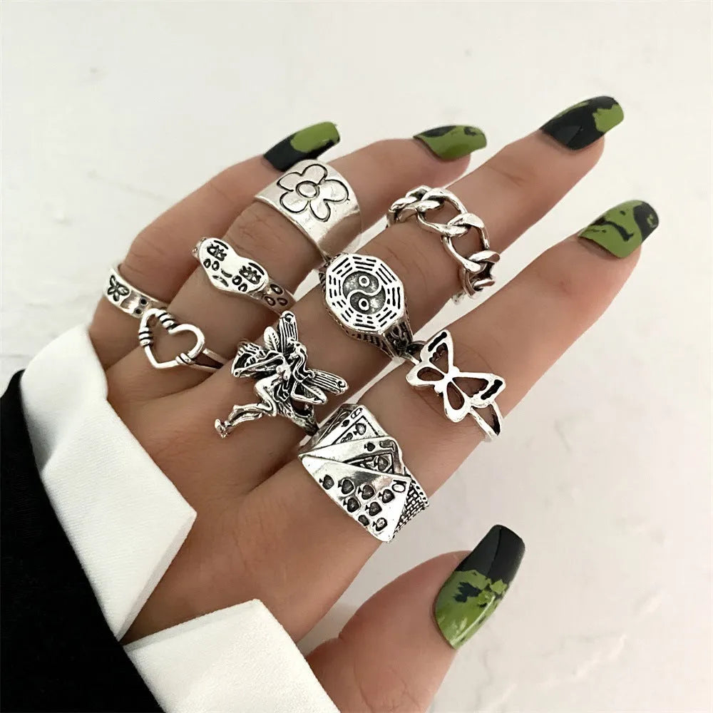 Alloy ring set with butterfly and snake retro geometric designs on display