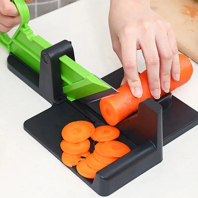 Green and red modern vegetable cutter with stainless steel blades for cutting carrots and potatoes.