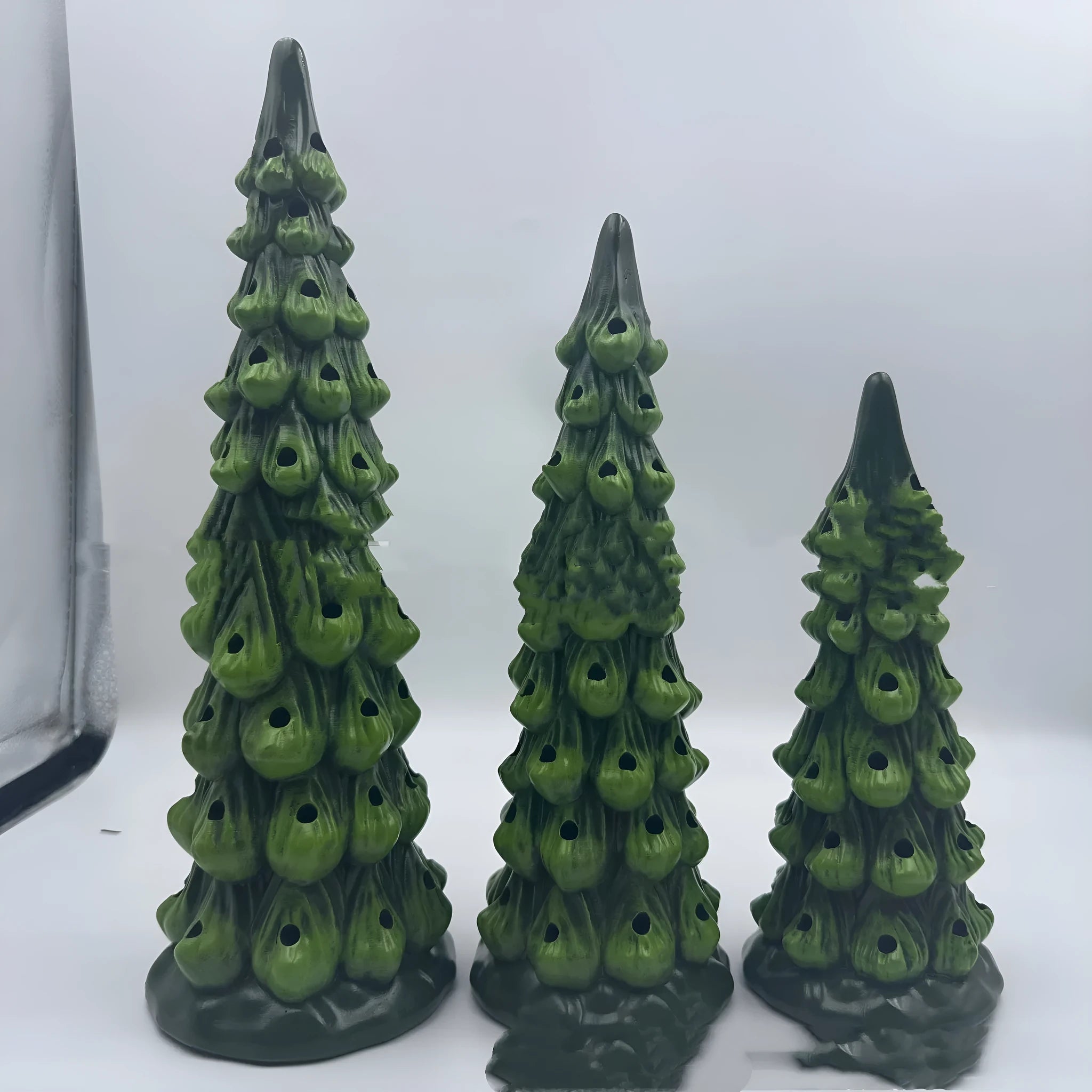 Set of three resin Christmas tree decorations in 20cm, 25cm, and 30cm sizes with LED lights.