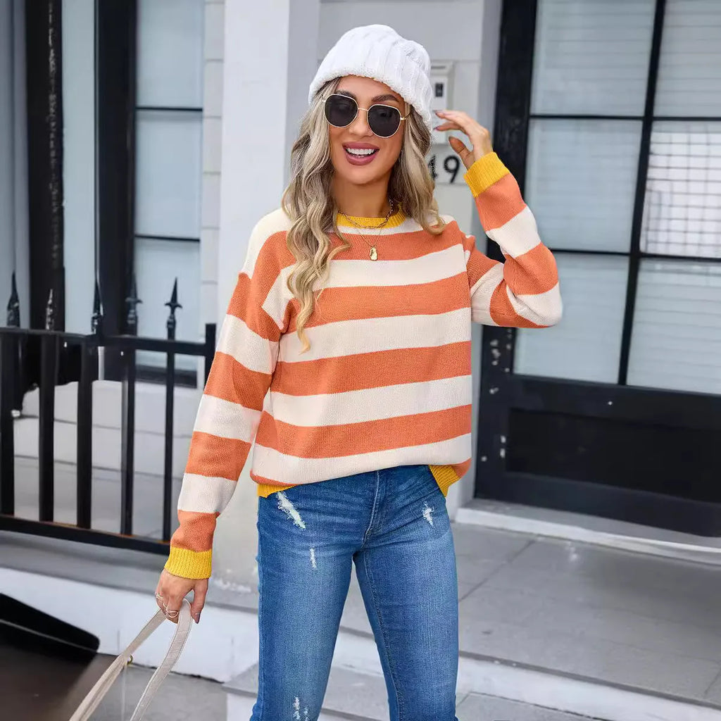 Women's loose fit long sleeve acrylic sweater in blue, showing round neck and regular sleeve.