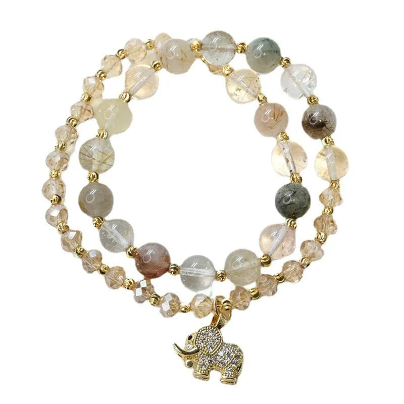 Retro style women's bracelet with colour hair crystal or strawberry quartz beads on a wrist.