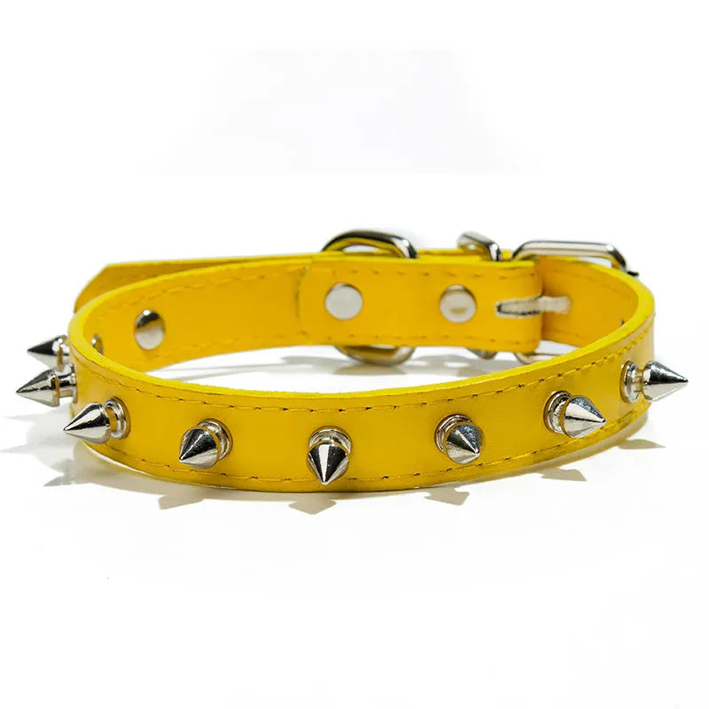Close-up of a studded black PU leather dog collar with metal spikes and a silver alloy buckle fastener.