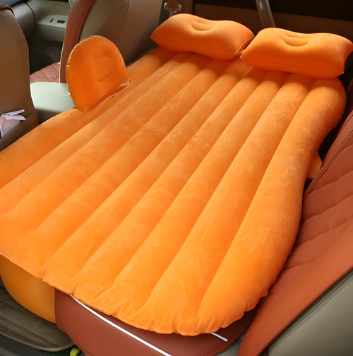 Universal inflatable car bed with flocking material, shown with pump, pillows, and storage bag.