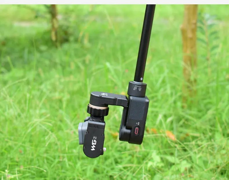 Black retractable aluminium selfie stick with Bluetooth remote, extended as a hand-held stabilizer.