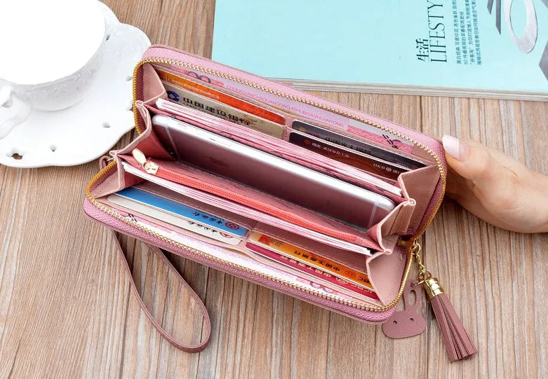 Women's long zip wallet in PU leather with polyester lining, 19.5 x 9.5 x 2.5 cm, shown in green.
