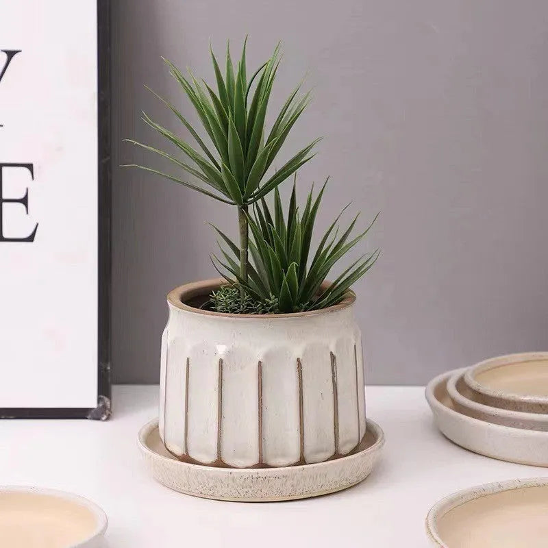Nordic simple striped ceramic flower pot in white, 14x13cm size, on a desktop with a small plant