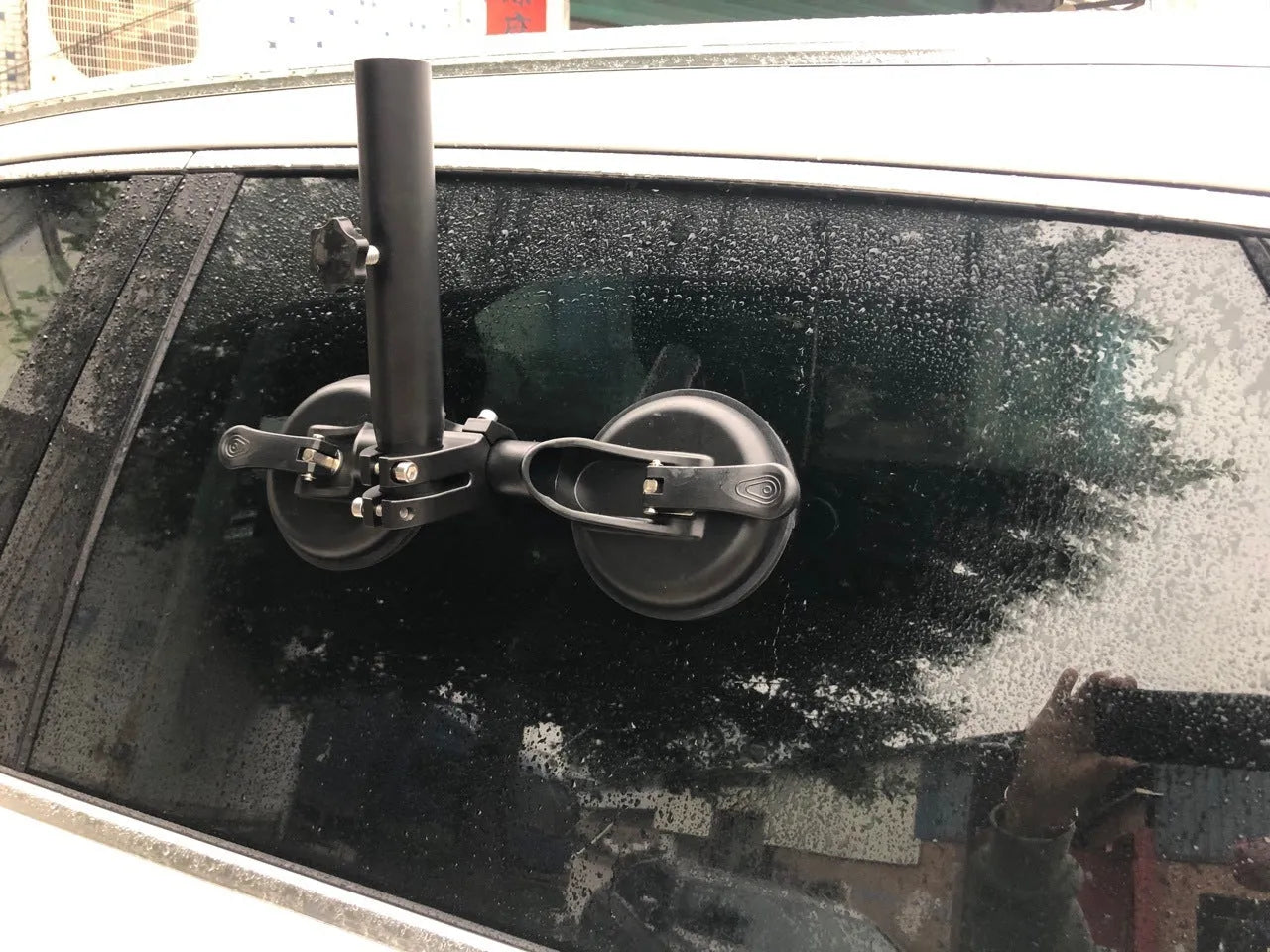Black off-road car glass sucker base with round rubber disc for windscreen mounting.