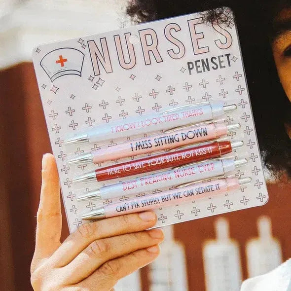 Set of five plastic retractable ballpoint pens with nurse-themed designs on the barrels.
