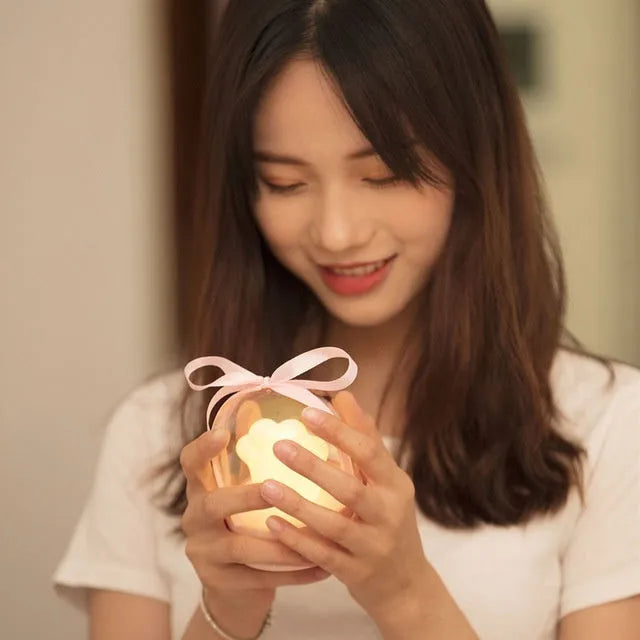 Grey and pink cat paw shaped USB rechargeable musical night light with adjustable brightness