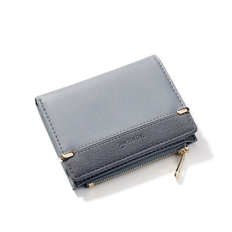 Black ladies short zipper wallet open to show multiple card slots, bill compartment, and change slot.