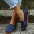 Women's black PU leather slip-on loafers with decorative stitching and a flat rubber sole.