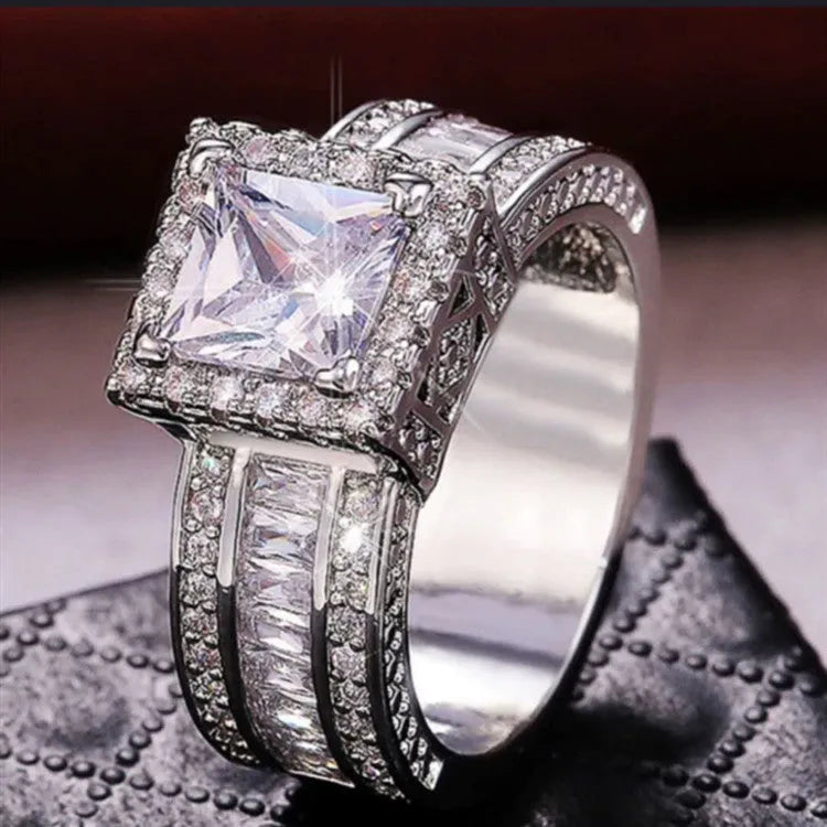 Geometric silver fashion ring for women in gold or white finish on a ring size mandrel.
