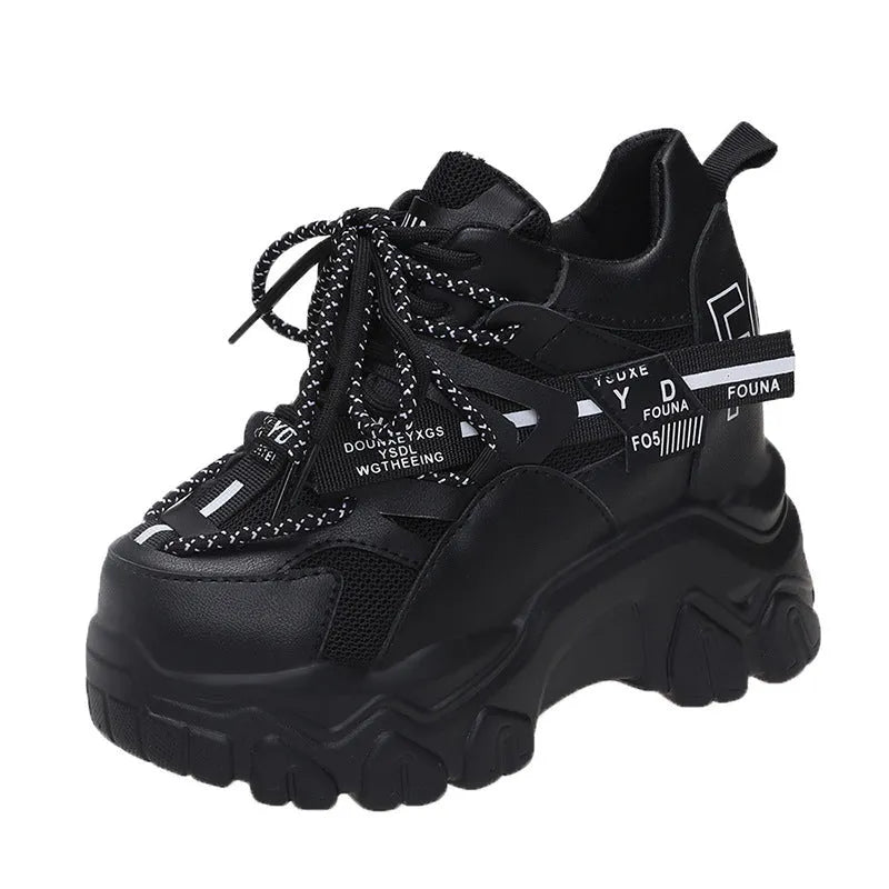 White women's low-top platform sports shoes with cross-strap detail on a rubber sole.