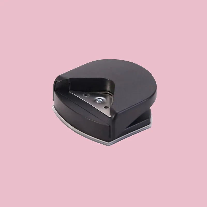 Business card corner cutter in black, blue, or pink colours showing plastic and metal construction