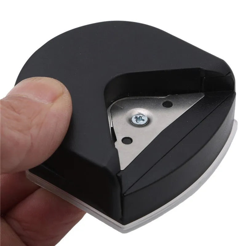 Business card corner cutter in black, blue, or pink colours showing plastic and metal construction