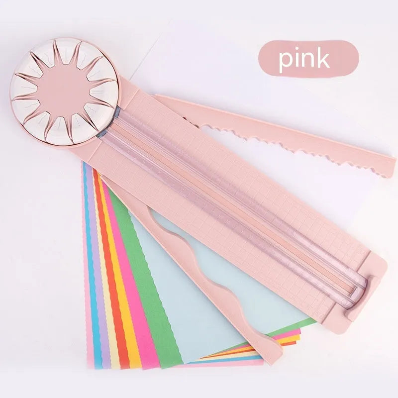 Pink plastic desktop paper cutting machine with a rotary blade for 12 different decorative edge patterns.