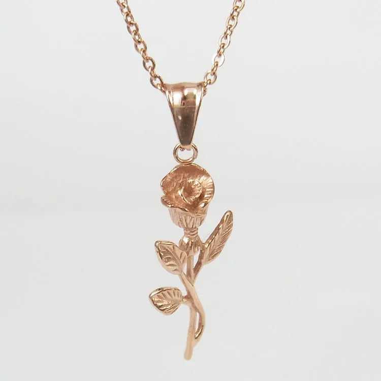 Stainless steel gold roses necklace for men with cross pendant and polished chain on display
