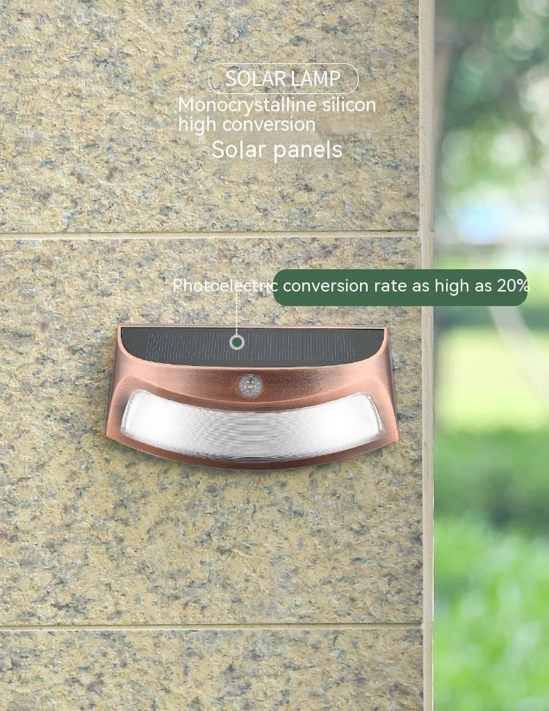 Solar-powered outdoor wall lamp with a smiling face design in a garden setting.
