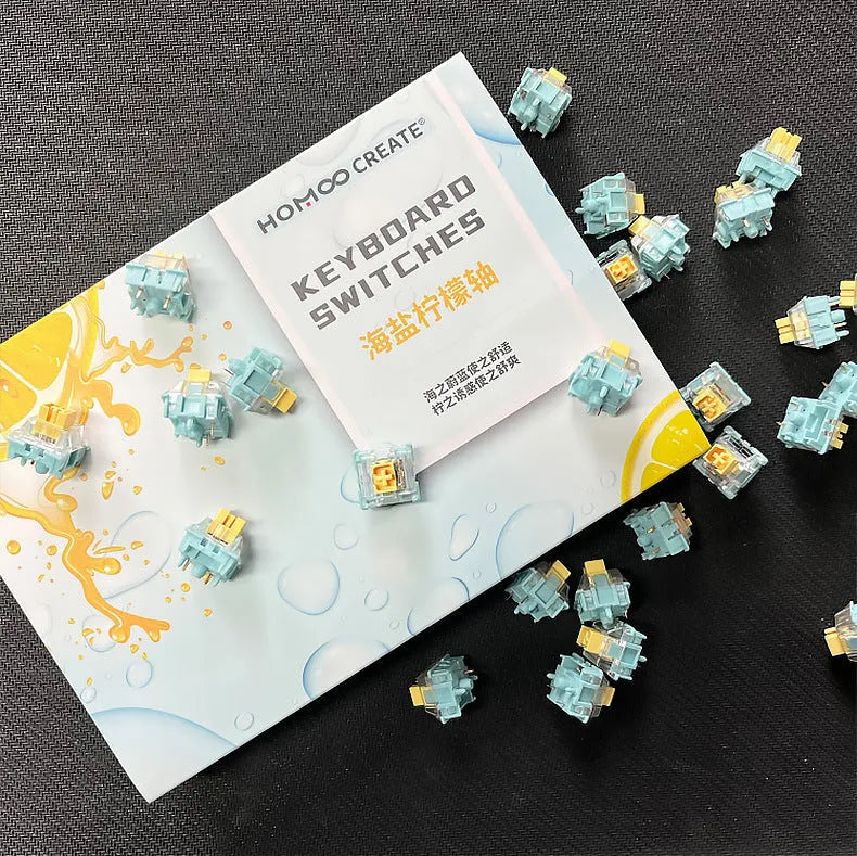 36 Sea Salt Lemon coloured mechanical keyboard switches with 3-pin connectors laid out on a table.