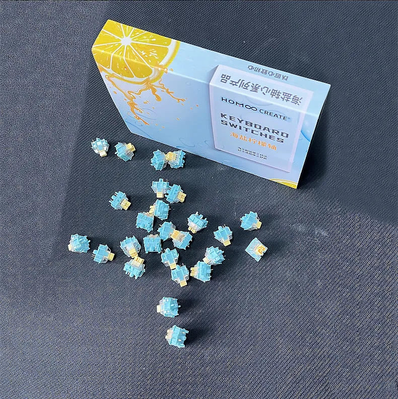 36 Sea Salt Lemon coloured mechanical keyboard switches with 3-pin connectors laid out on a table.
