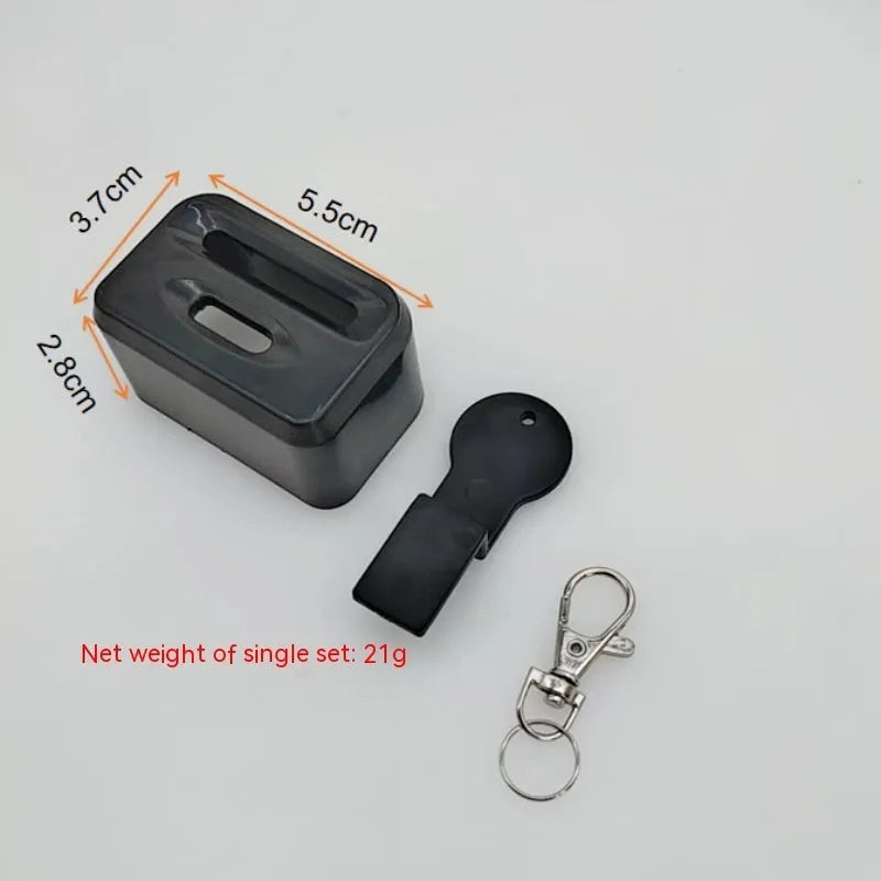 Black plastic seat belt buckle clamp holder for child car seat safety.