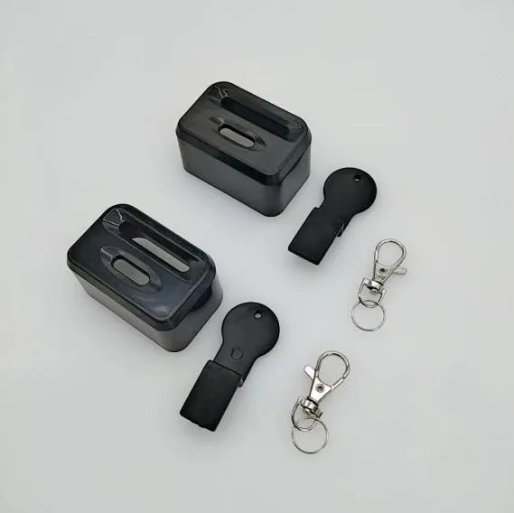 Black plastic seat belt buckle clamp holder for child car seat safety.