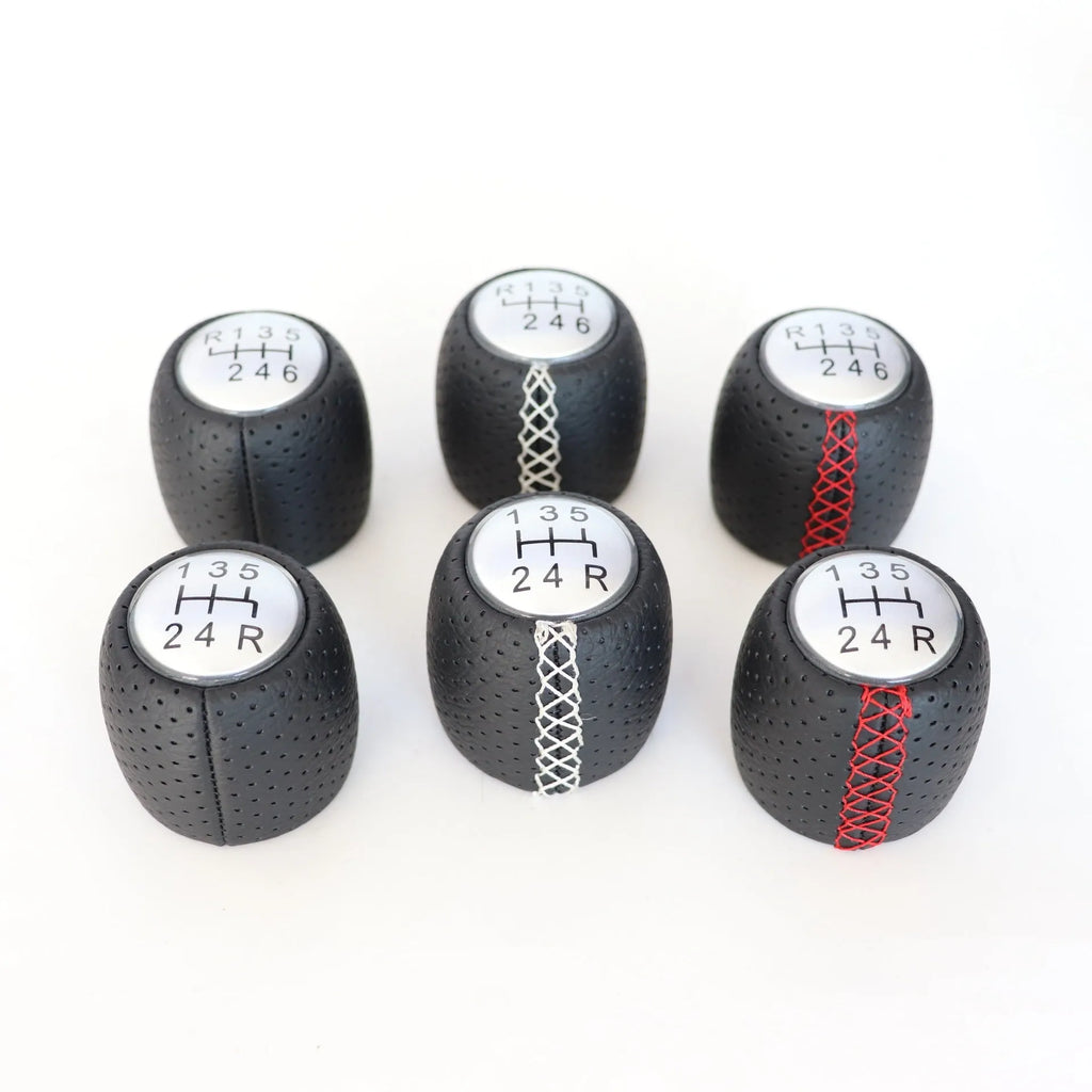 Perforated leather gear shift handball for Alpha car in black, red, and white line colour options.