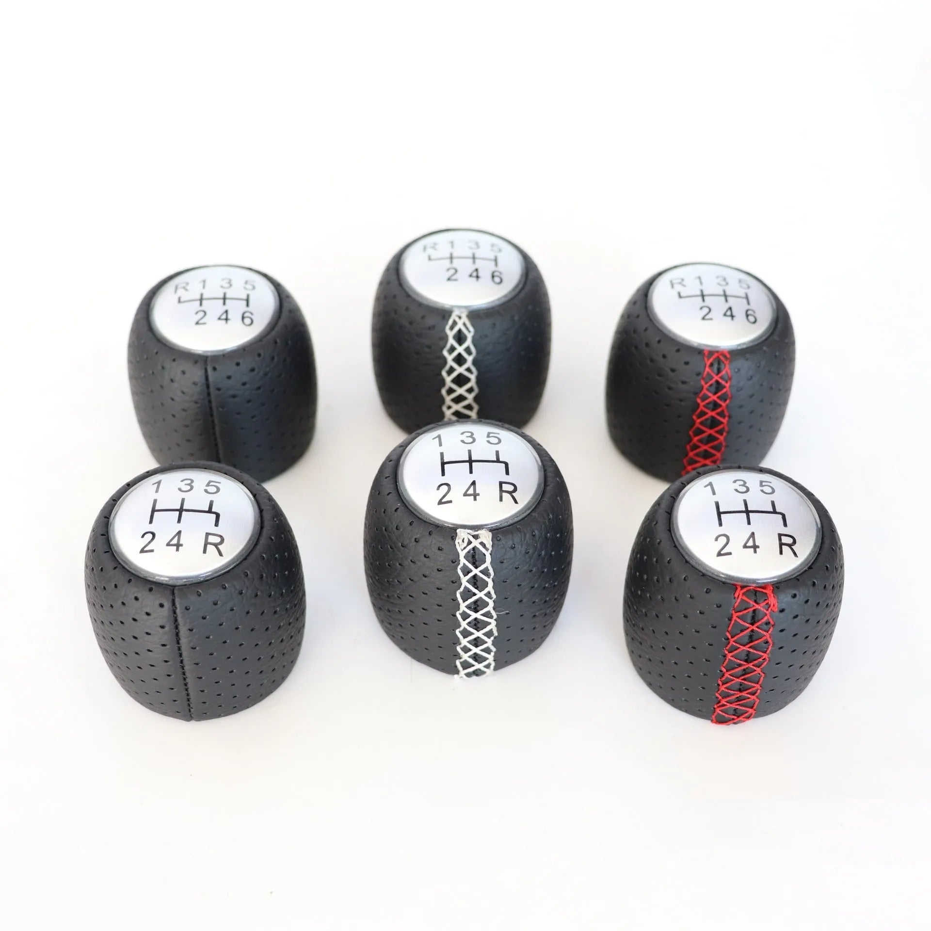 Perforated leather gear shift handball for Alpha car in black, red, and white line colour options.