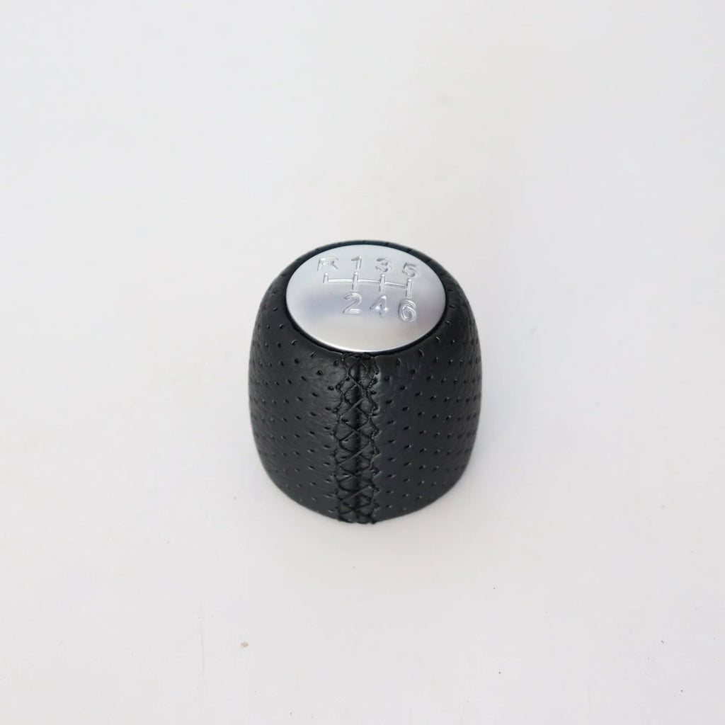 Perforated leather gear shift handball for Alpha car in black, red, and white line colour options.