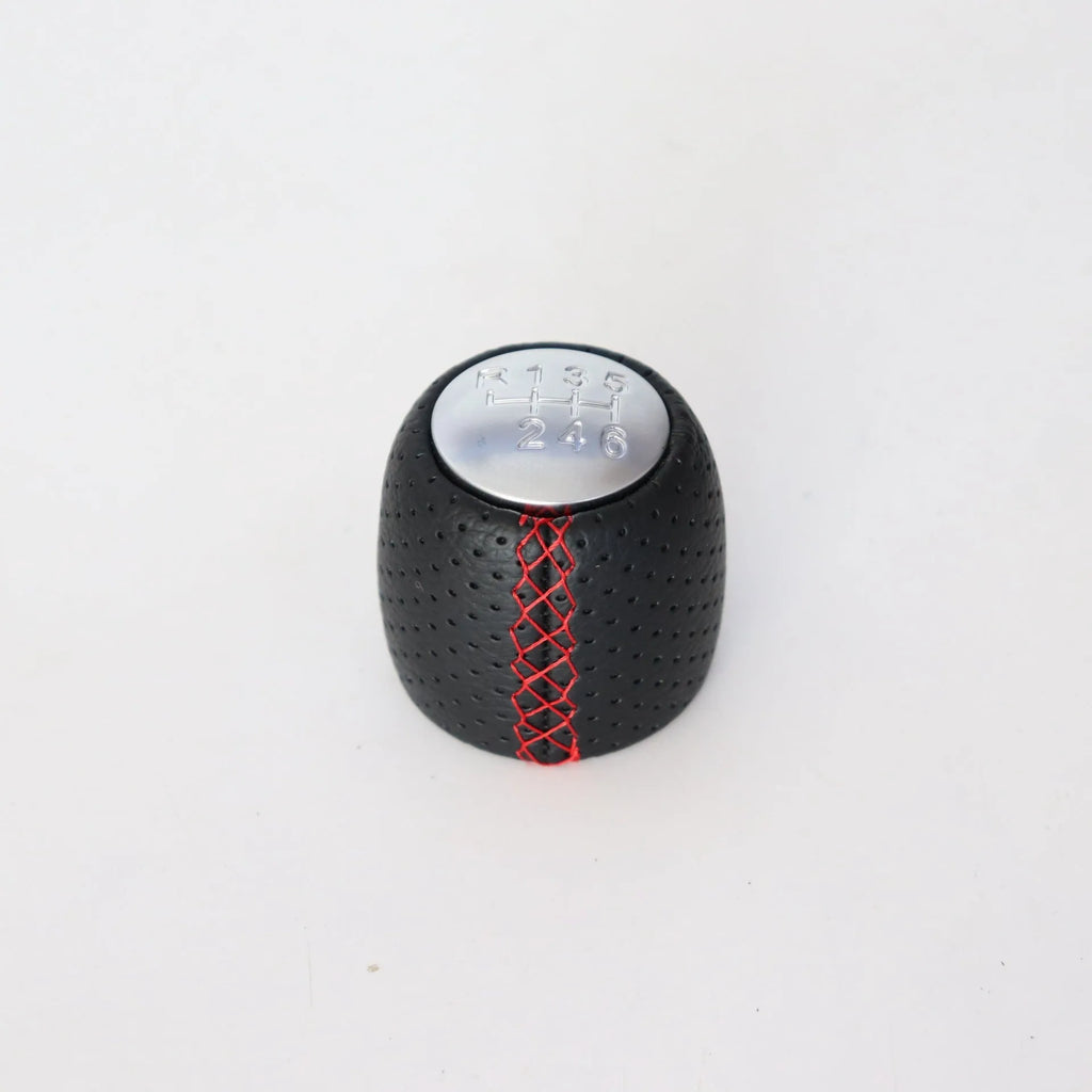 Perforated leather gear shift handball for Alpha car in black, red, and white line colour options.