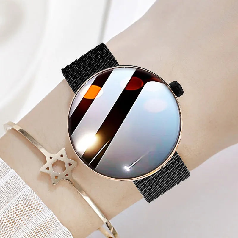 Circular smart watch with metal strap on a woman's wrist, showing colour touchscreen display.