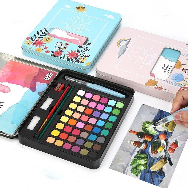 Open box showing 48 solid watercolour paint cakes in various colours including black knight, pink, and blue.