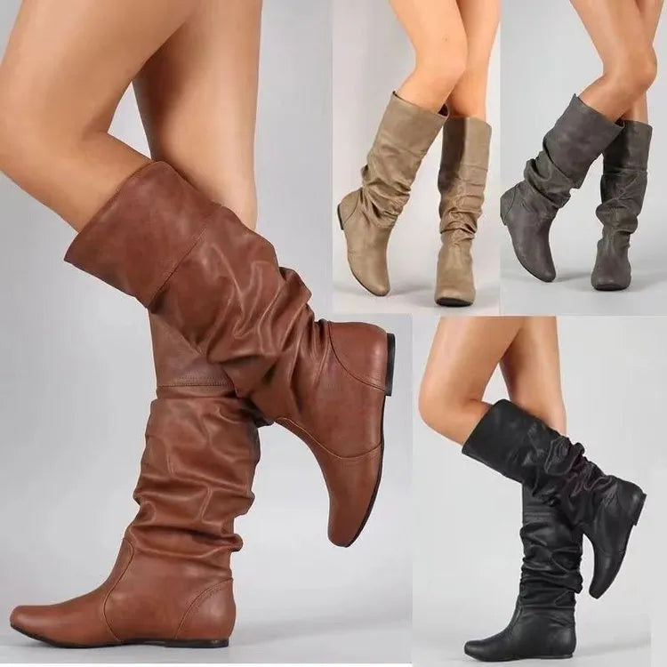 Women's flat slip-on long boots in black with round toe and high cylinder shaft, on a rubber sole.